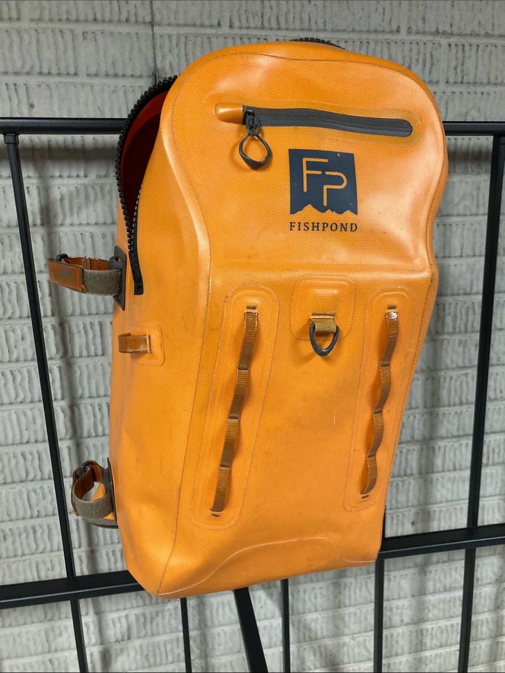 Fishpond Thunderhead submersible backpack in rarer orange color.  Zipper closure